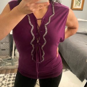 Woman’s sleeveless lace up front embelissed top